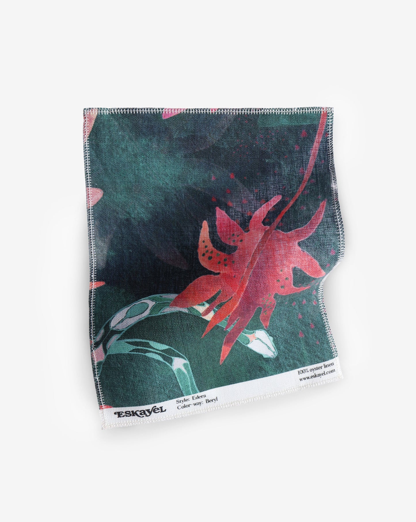 A Edera Fabric Sample and Beryl leaf sample on a piece of fabric