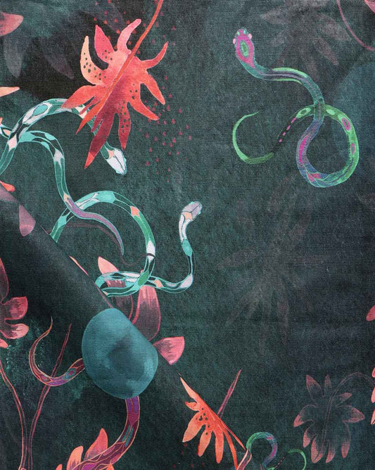 A fabric with a dark blue colorway and Edera Fabric-inspired pattern, featuring colorful snakes and flowers on it