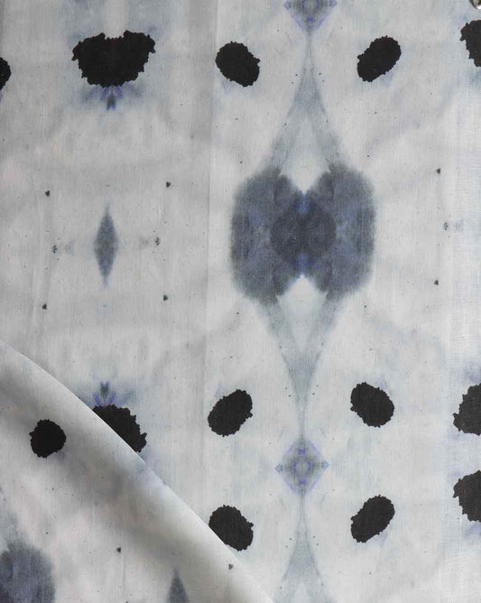 A close up of Galileo Glass Fabric Indigo featuring fluid pigments in a blue and black tie dyed pattern