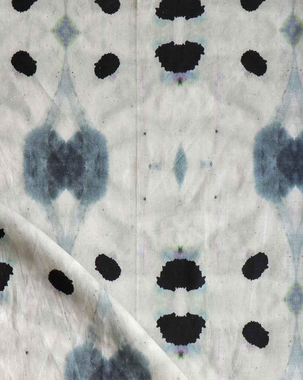 A close up of Galileo Glass Fabric Shale with fluid pigments, creating abstract patterns