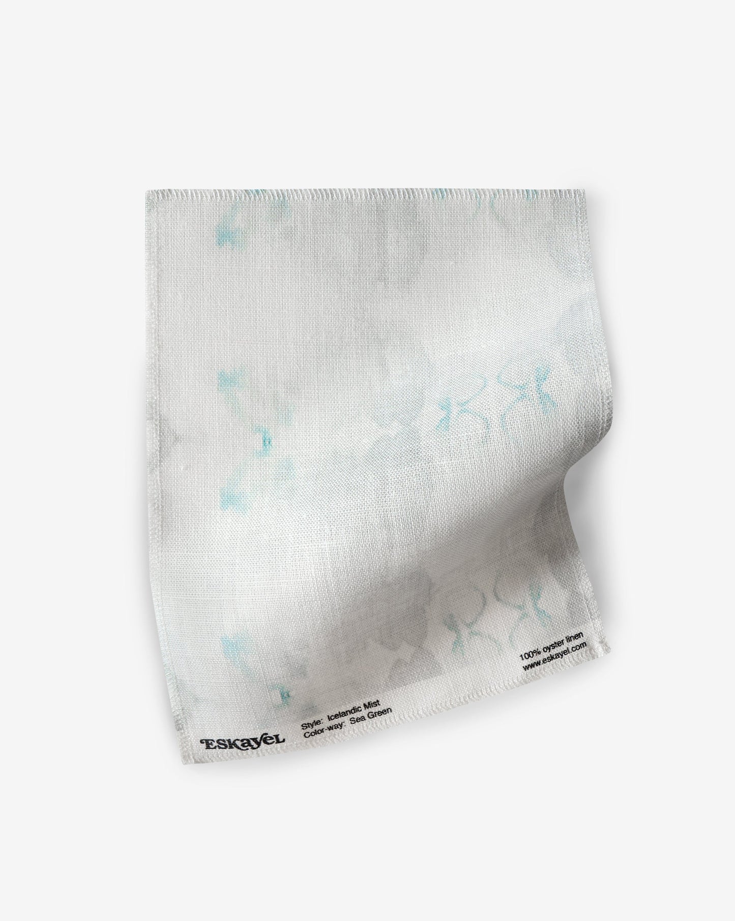 A white Icelandic Mist fabric made of high-end luxury Sea Green fabric with blue and white flowers on it