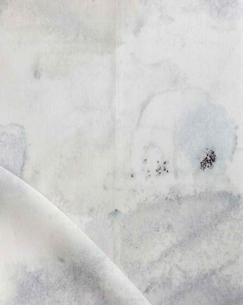 A close up image of Kotoubia Fabric Blanca, a white and blue luxury fabric from Morocco
