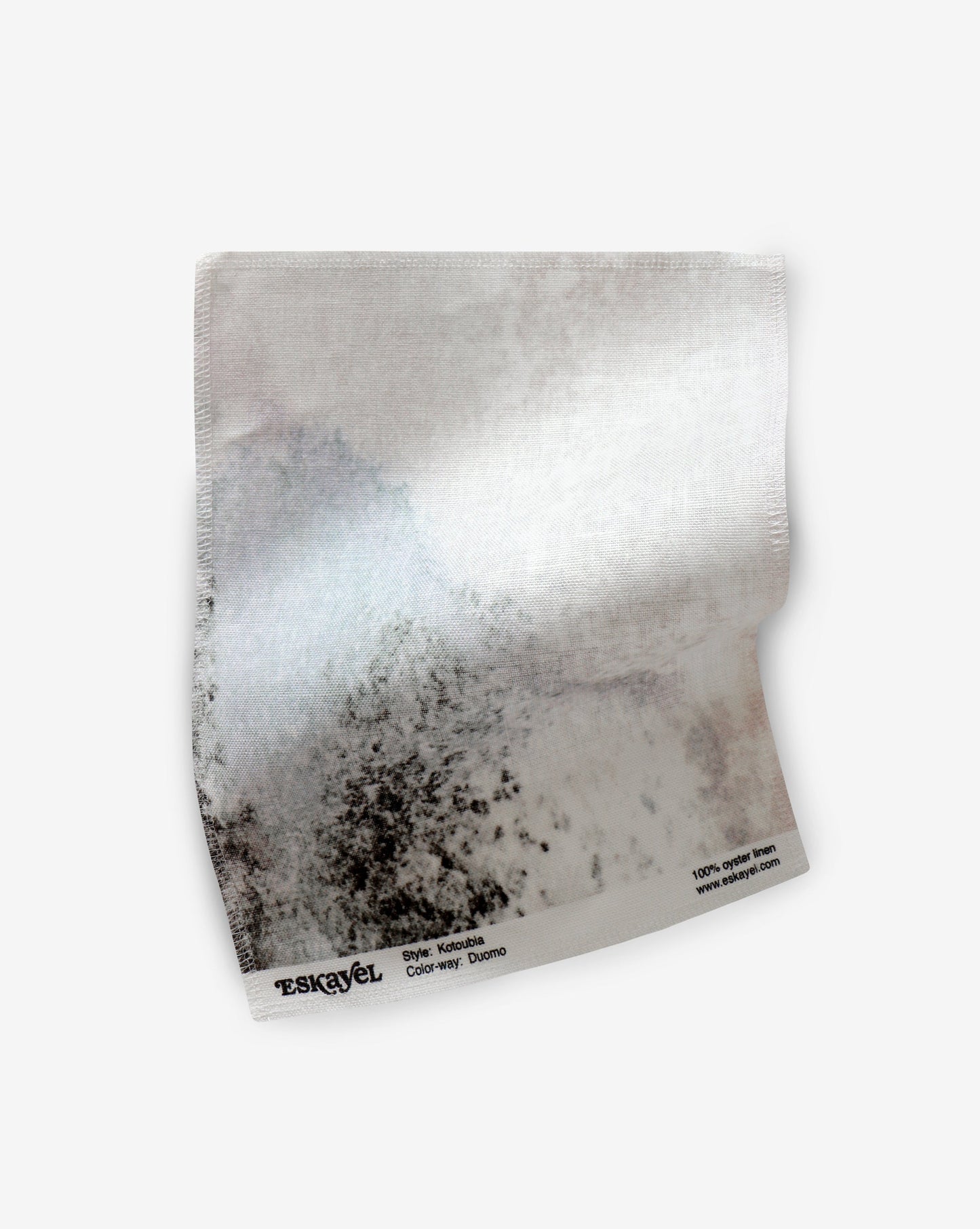A Kotoubia Fabric Sample Duomo piece of paper with black and white splatters on it
