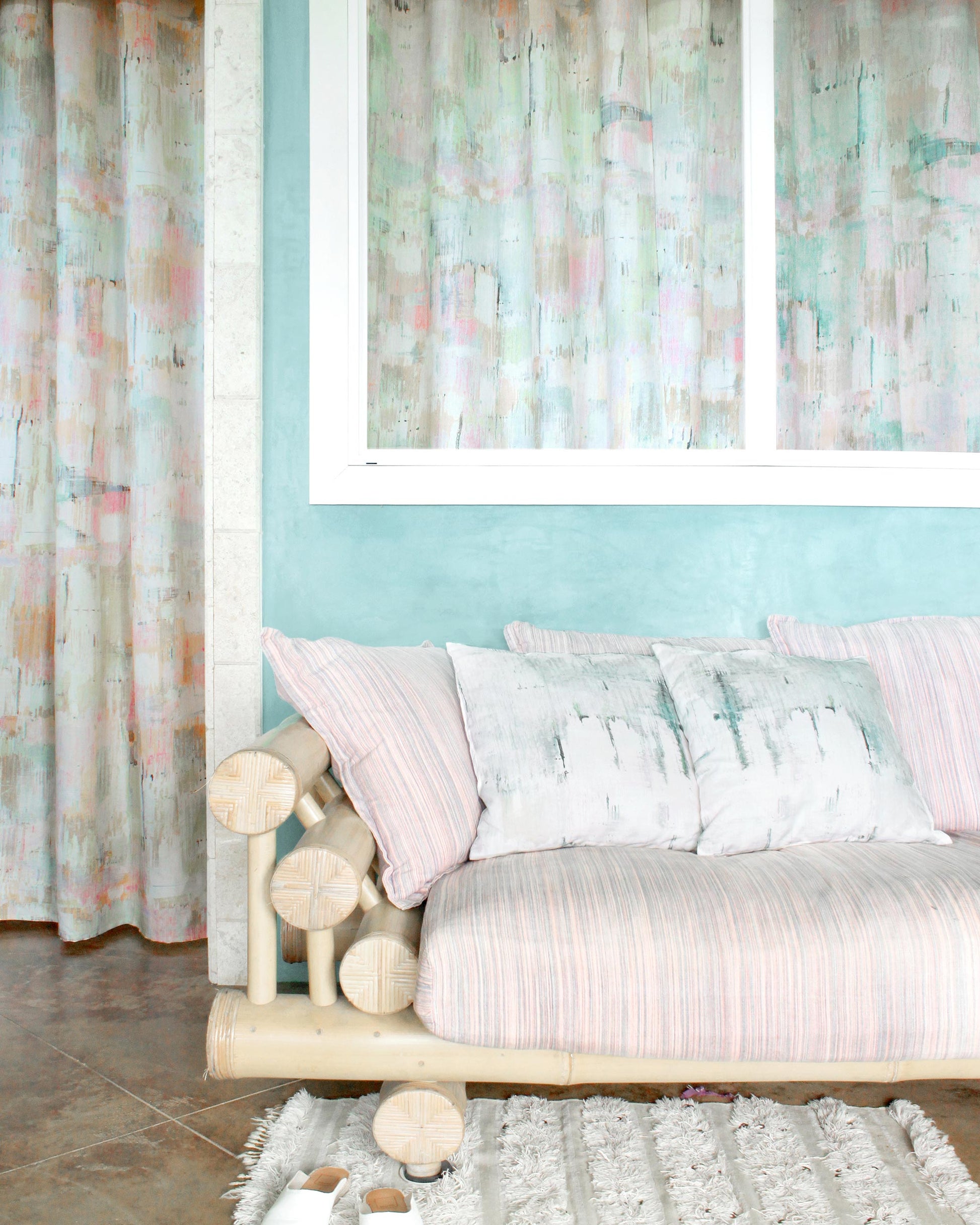 A couch in a room with a Cherifia Fabric Karmouss artwork