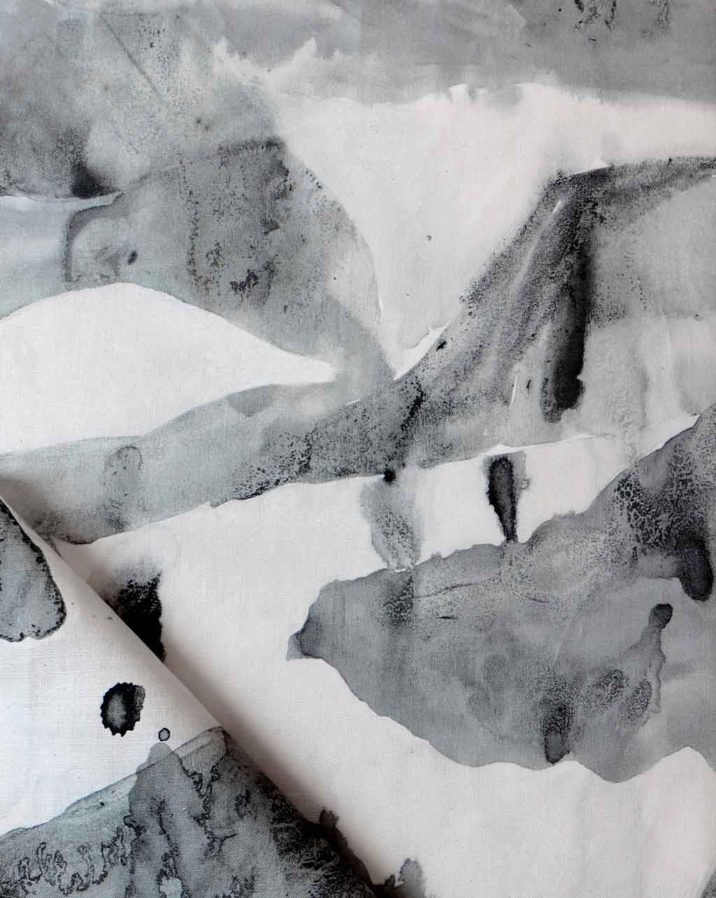 A black and white Mani Fabric Phyllite painting on a piece of fabric