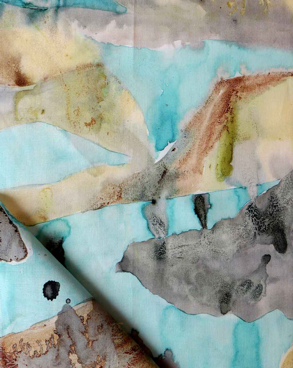 A watercolor painting on a piece of Mani Fabric Sage in Greece showcasing vibrant colorways of the Mani region