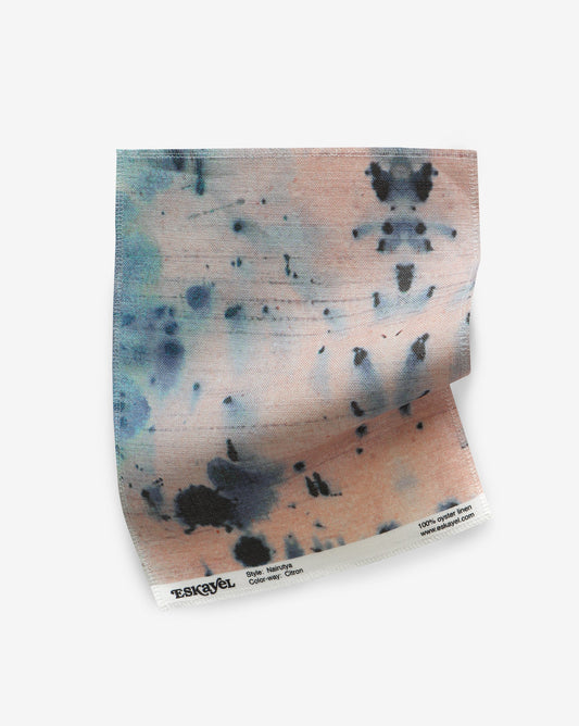 A Nairutya Fabric Sample Citron piece of paper with blue and pink paint on it