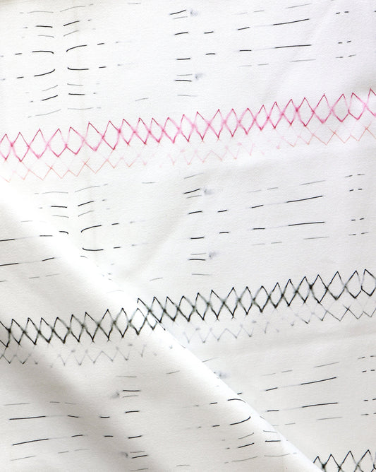 A close up of Native Stripe Fabric Black + Crimson with a graphic pattern of black and pink lines
