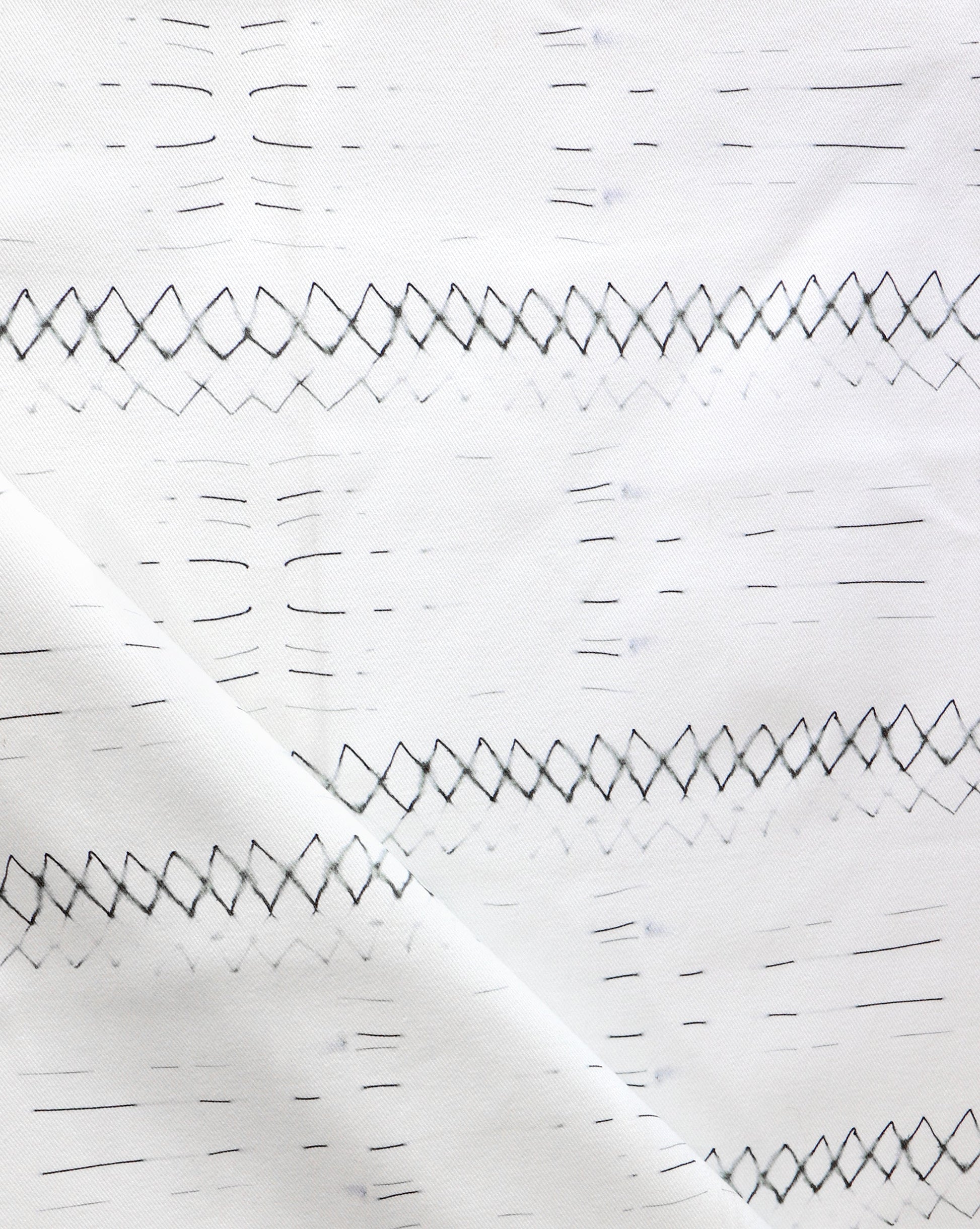 A close up of Native Stripe Fabric Black + White, perfect for custom fabric or interior schemes