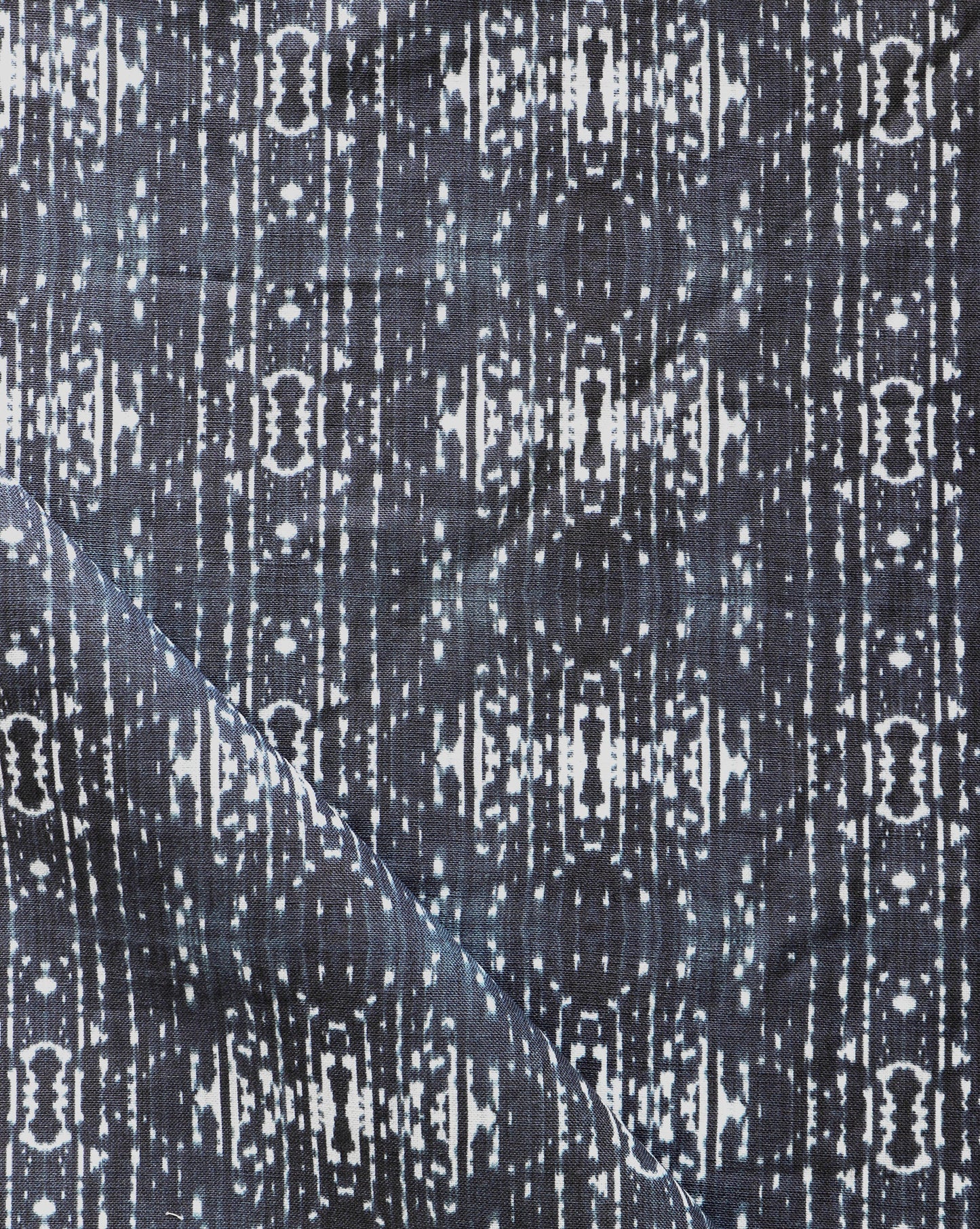 A close up of a black and white patterned Omaha Kinship Fabric, inspired by the Indigo Ikat pattern