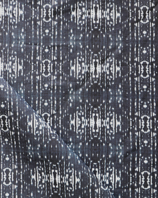 A close up of a black and white patterned Omaha Kinship Fabric, inspired by the Indigo Ikat pattern