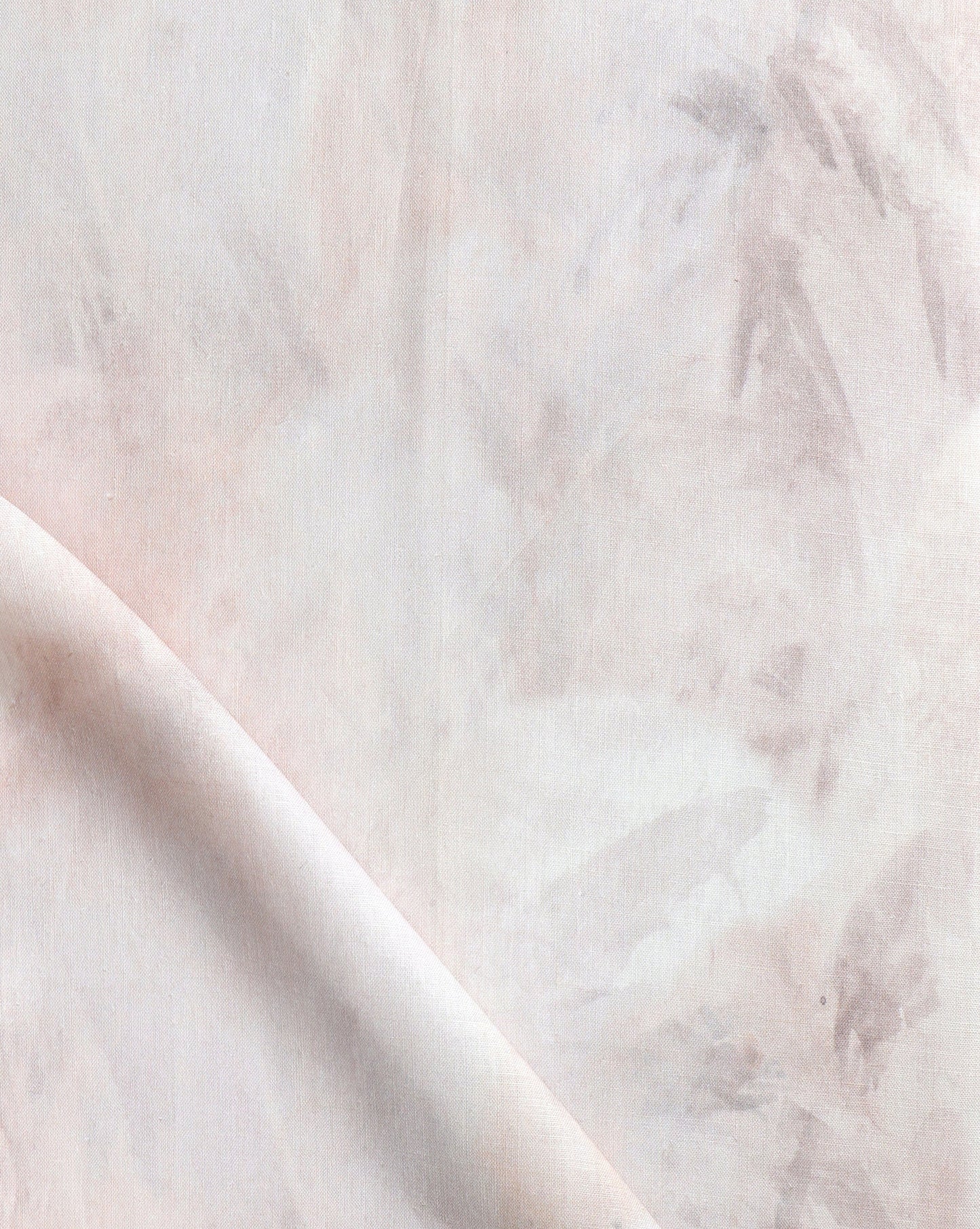 A close up of Palmeti Fabric with peachy pink tones