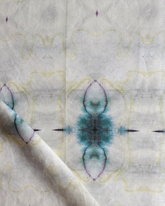 A close up of Pulsar Fabric Sand with blue and purple designs