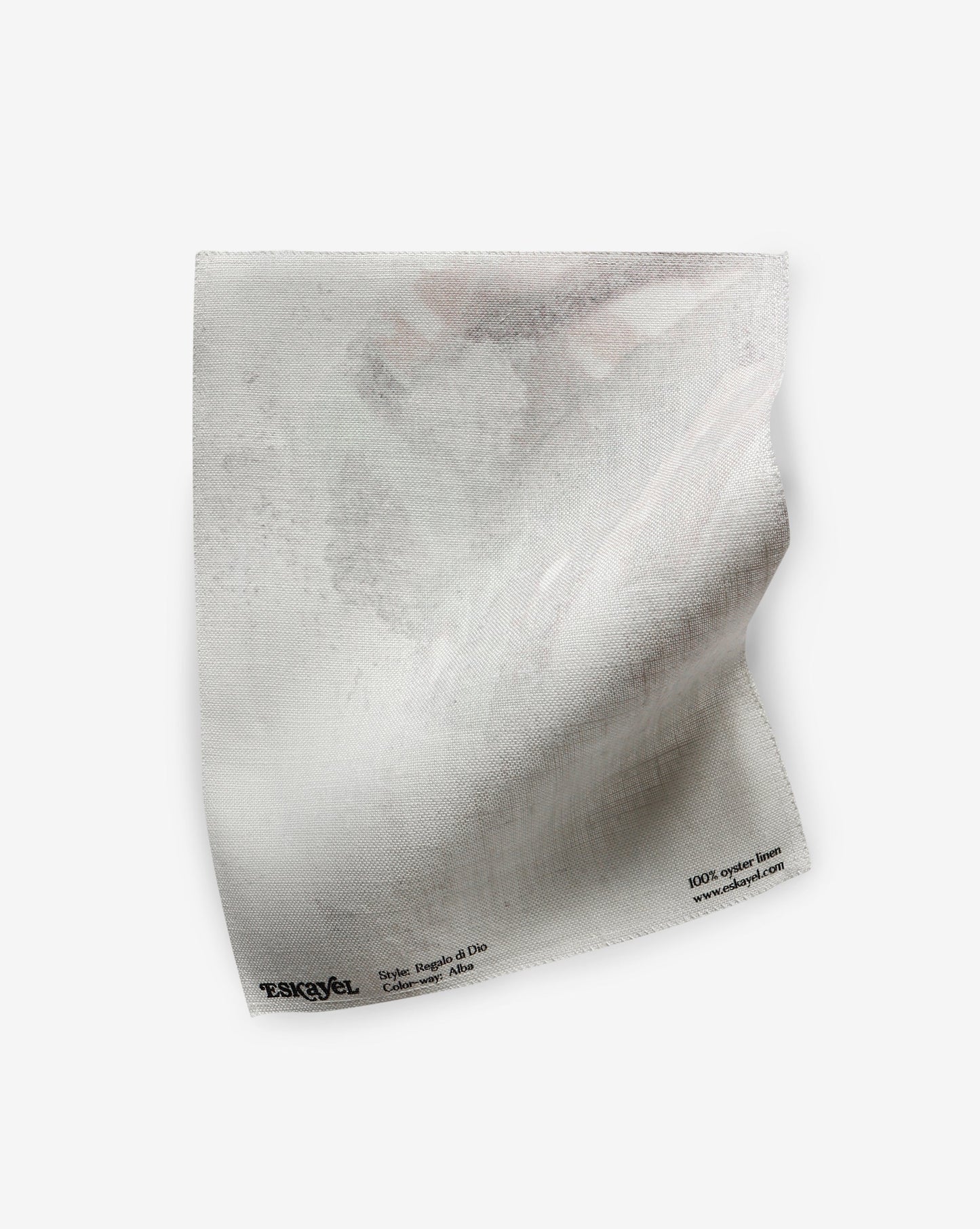 A white piece of paper on a Regalo di Dio Fabric Alba surface