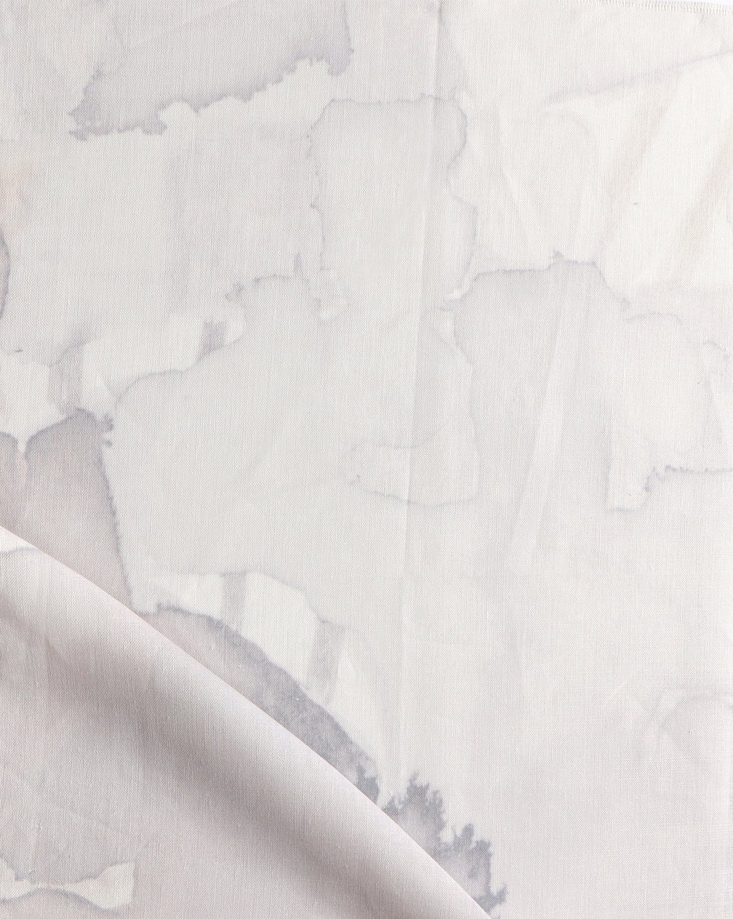 A close up of a Sea Galaxy Fabric||Coral custom drapes with white paint on it.