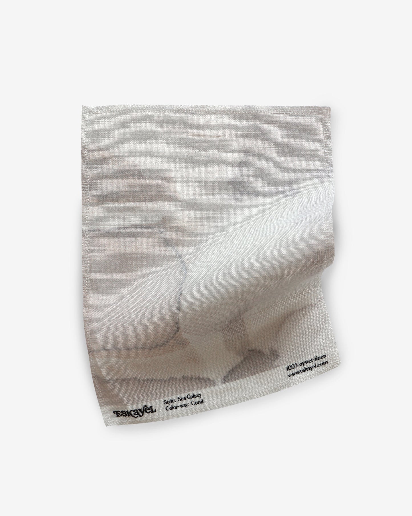 A Sea Galaxy Fabric||Coral napkin on a white surface.