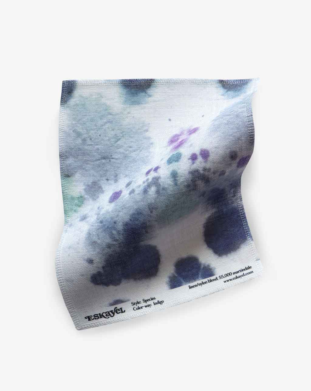 A piece of Species Fabric Indigo with a kaleidoscopic effect design on it