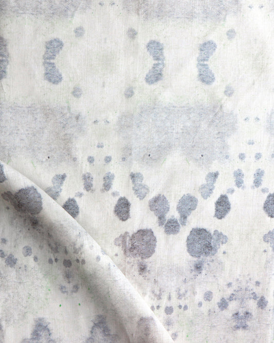 A close up of Species Fabric with a blue and green kaleidoscopic pattern, showcasing the ink's vibrant colors