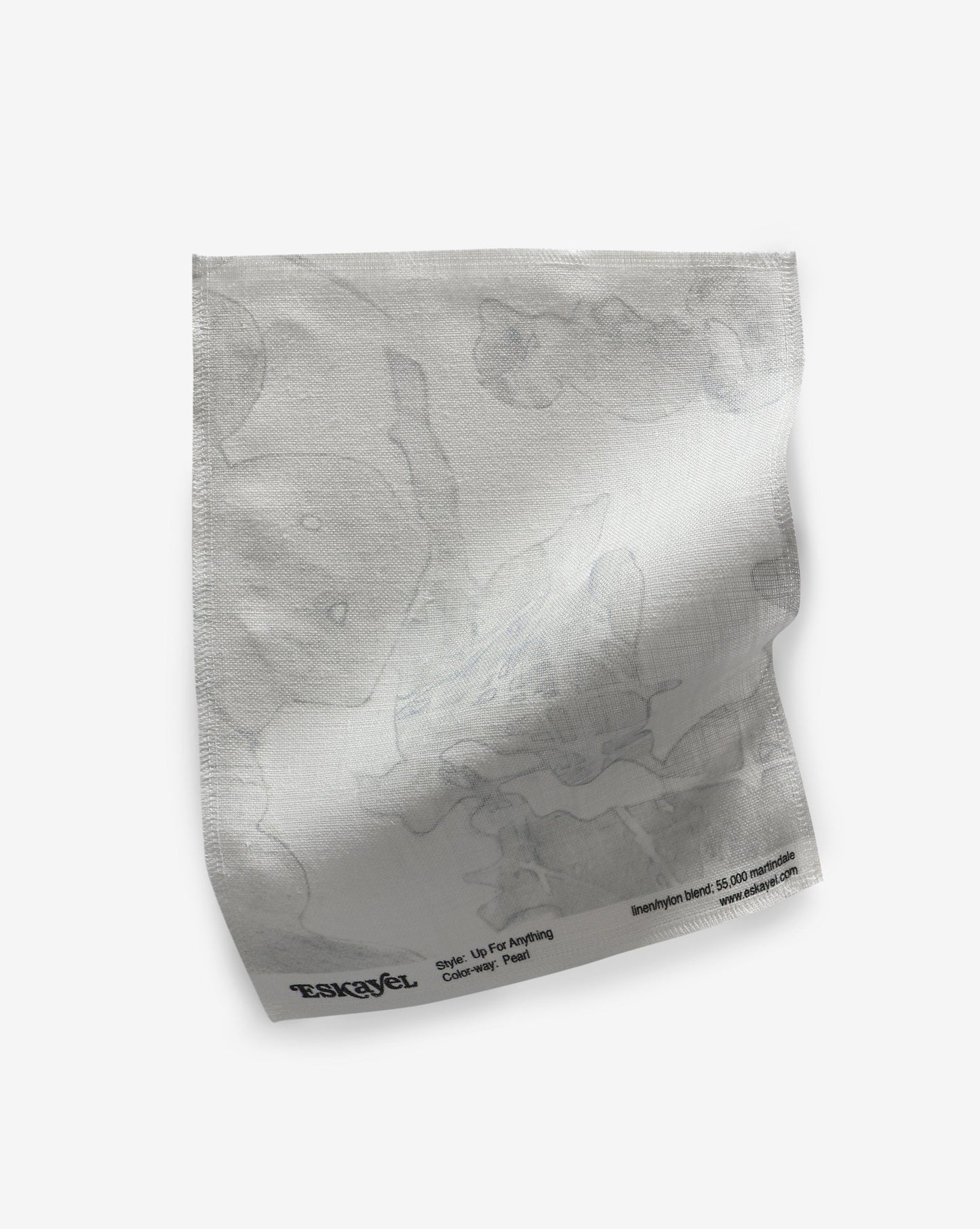 A white Up For Anything Fabric Sample Pearl napkin on a white surface