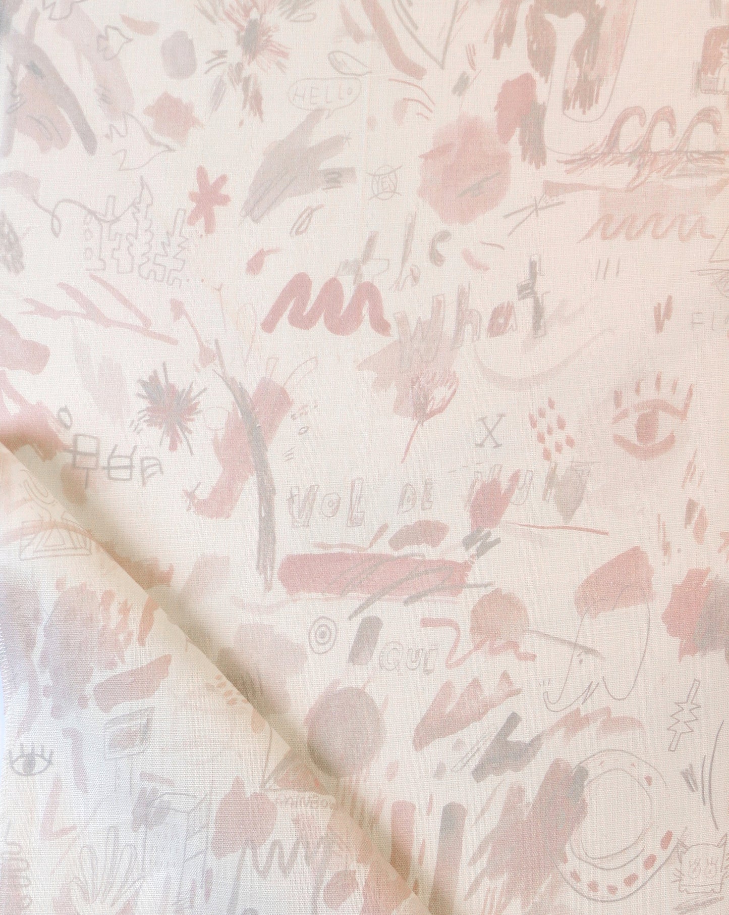 A Vol de Nuit Fabric Light Peach with a lot of scribbles on it