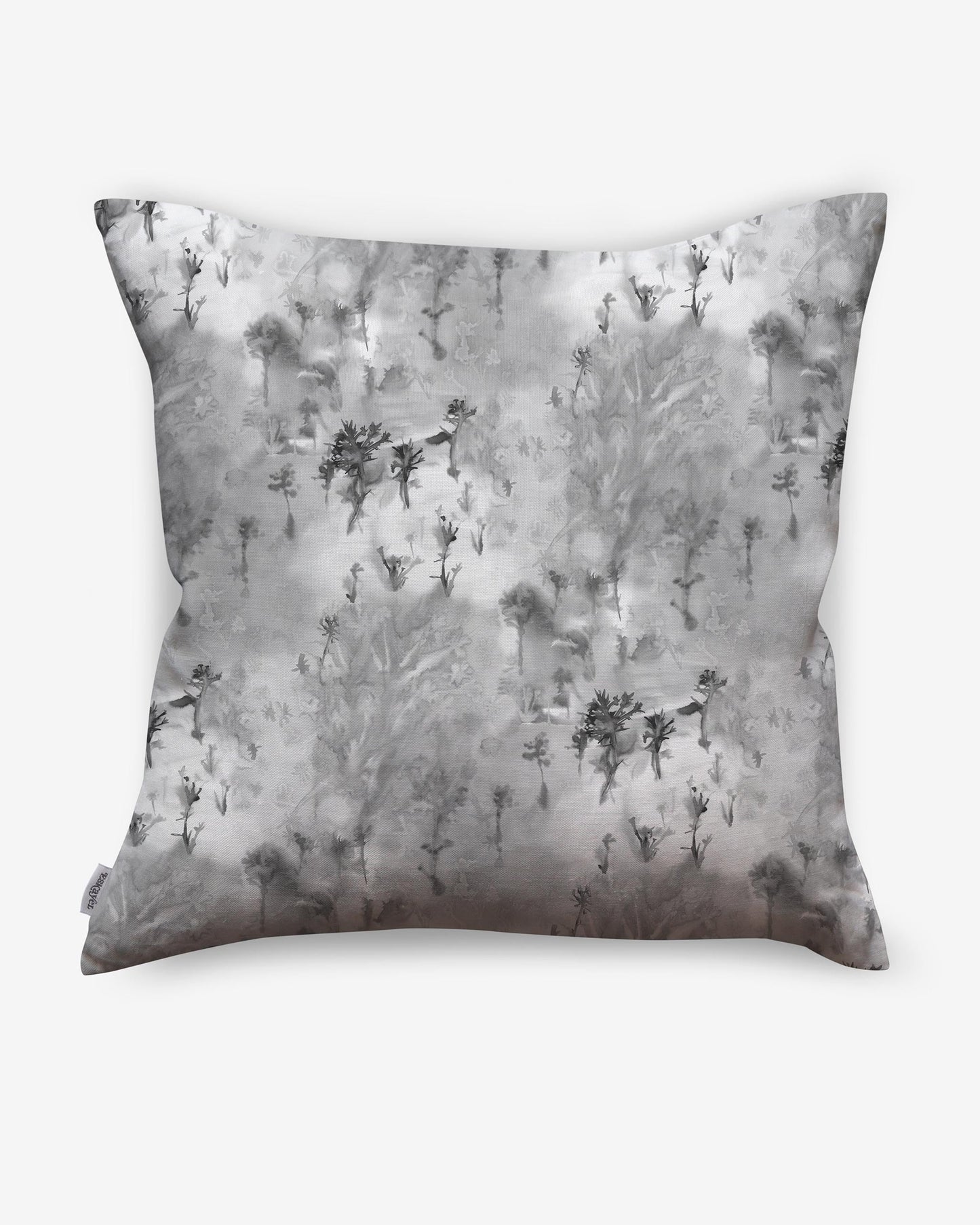 A Phyllite pillow crafted with luxury fabric and adorned with a black and white pattern