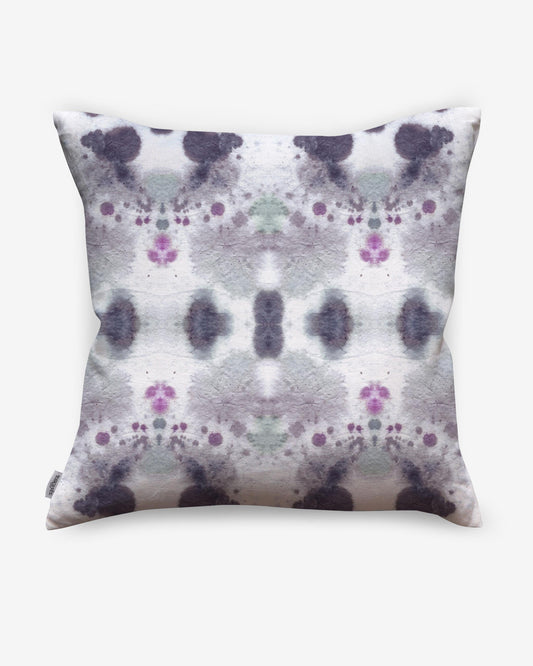 A Species Pillow Indigo with purple and green flowers on it creates a kaleidoscopic effect