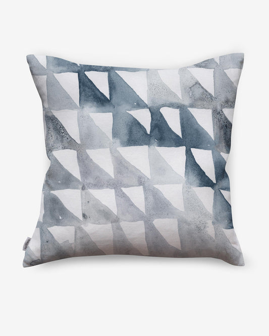 A Triangle Checks Pillow Ocean with blue and white triangles, part of a geometric sequence, on it