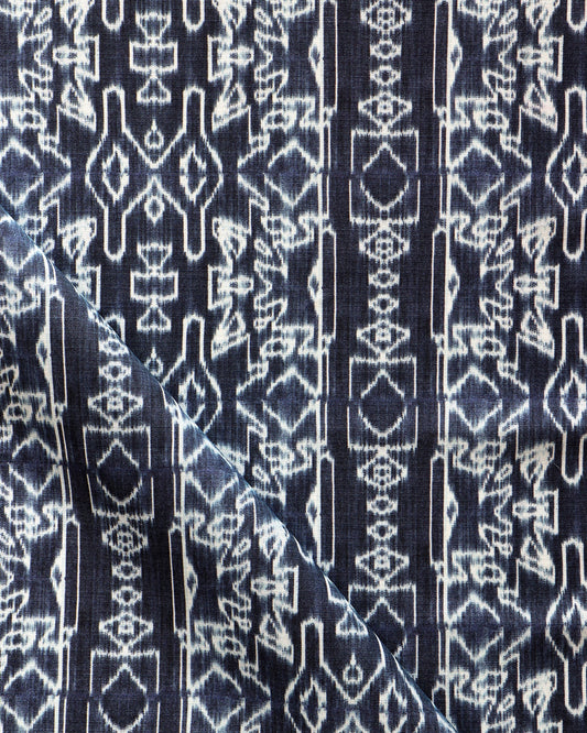 A fabric with the Akimbo Performance Fabric Indigo Ikat pattern