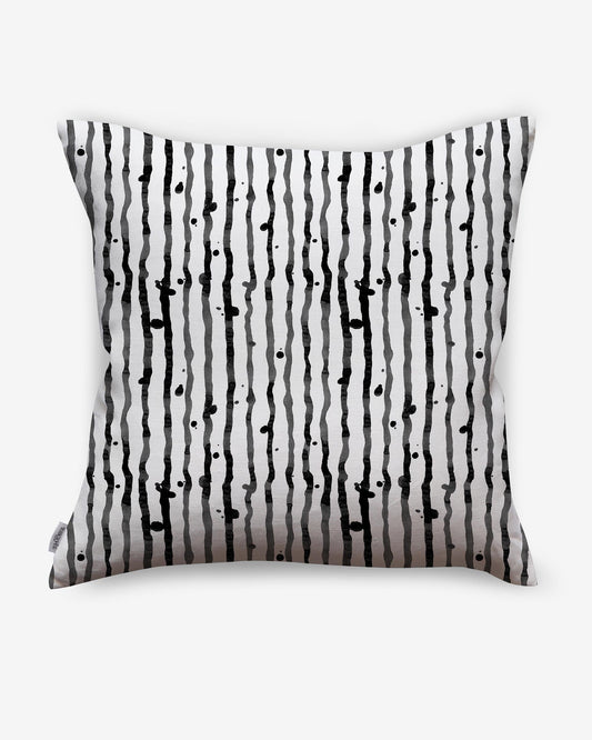 A Drippy Stripe Outdoor Pillow Slate with a black and white pattern on it