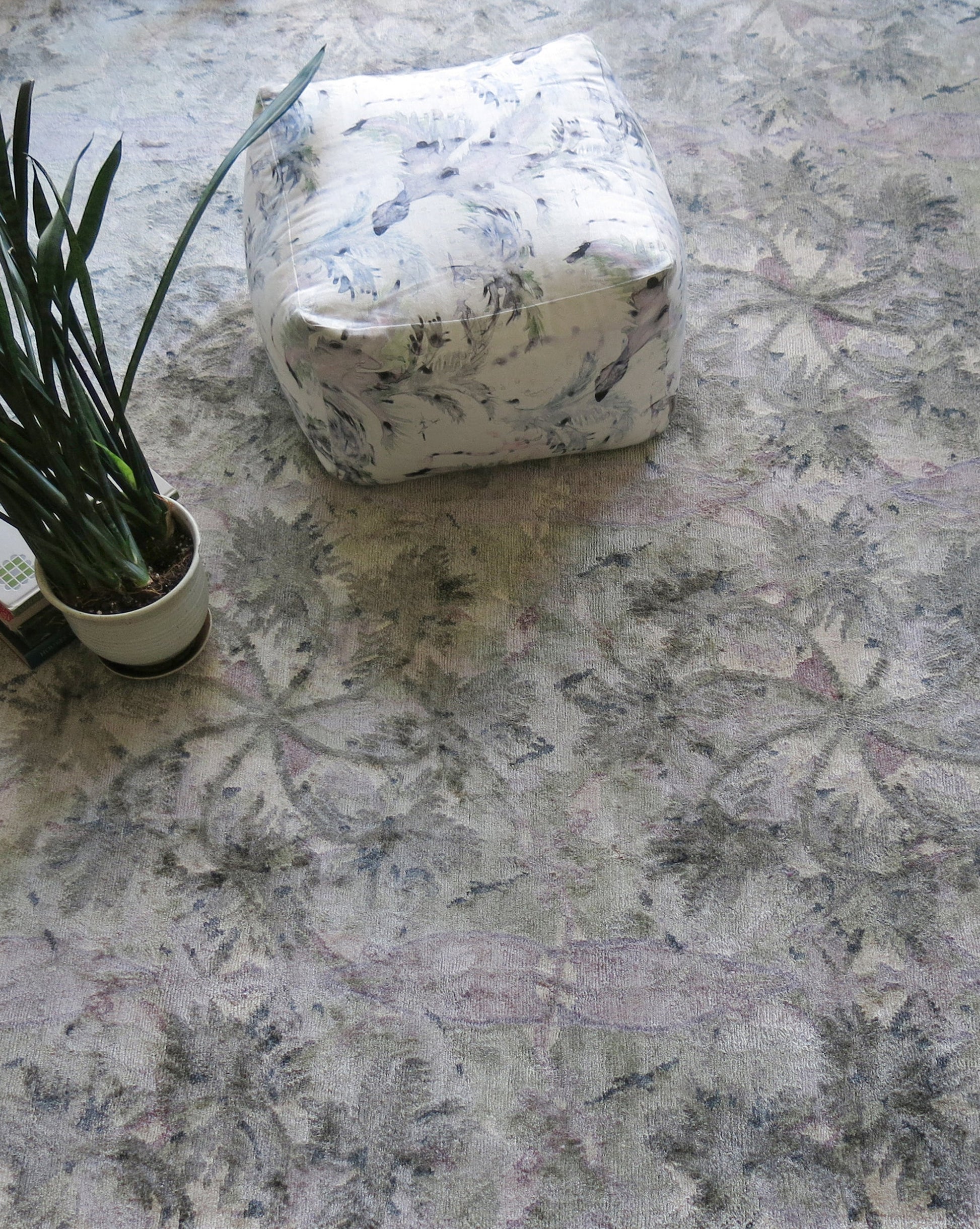 A Laurel Forest Hand Knotted Rug Dove with swaying palms on it