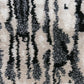 A close up image of a tactile Biami Hand Knotted Rug Black with a Biami pattern