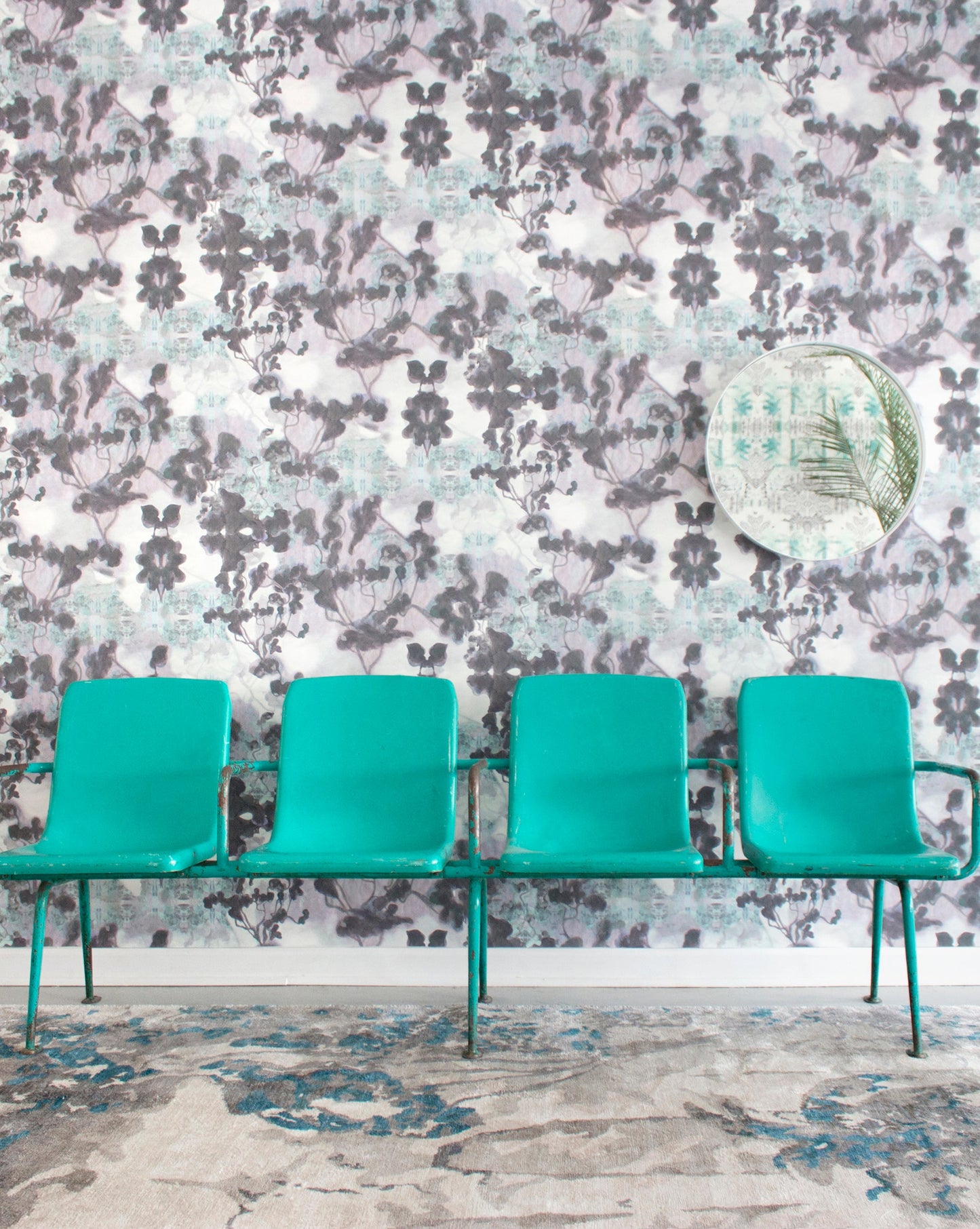 A row of green chairs in front of a Cabrillo Hand Knotted Rug  Stone wallpapered wall