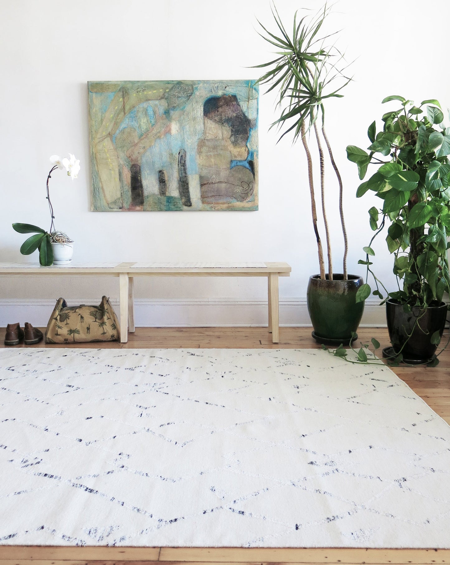 A white rug in a room with a Peaks Flatweave Rug Snow on it