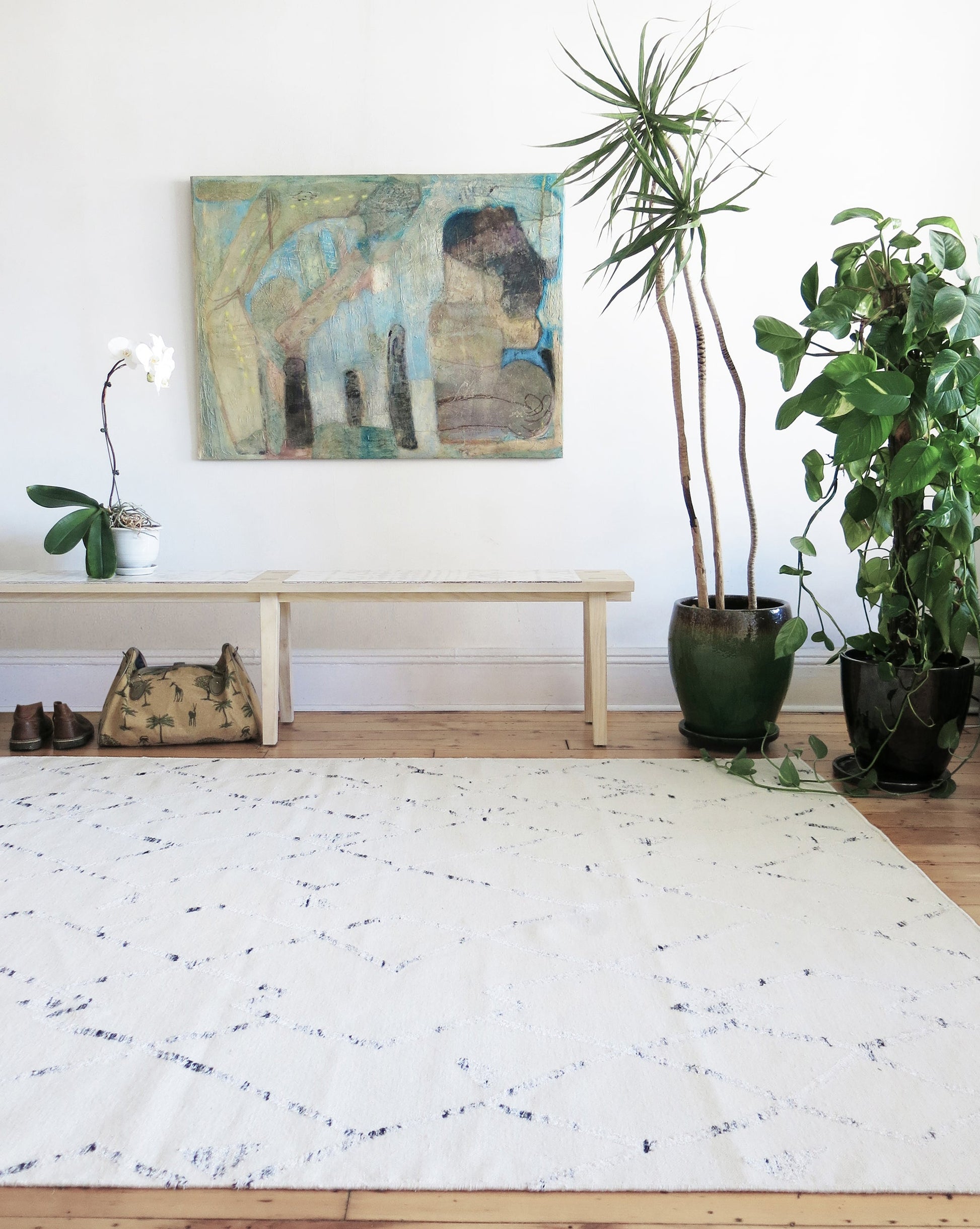 A white rug in a room with a Peaks Flatweave Rug Snow on it