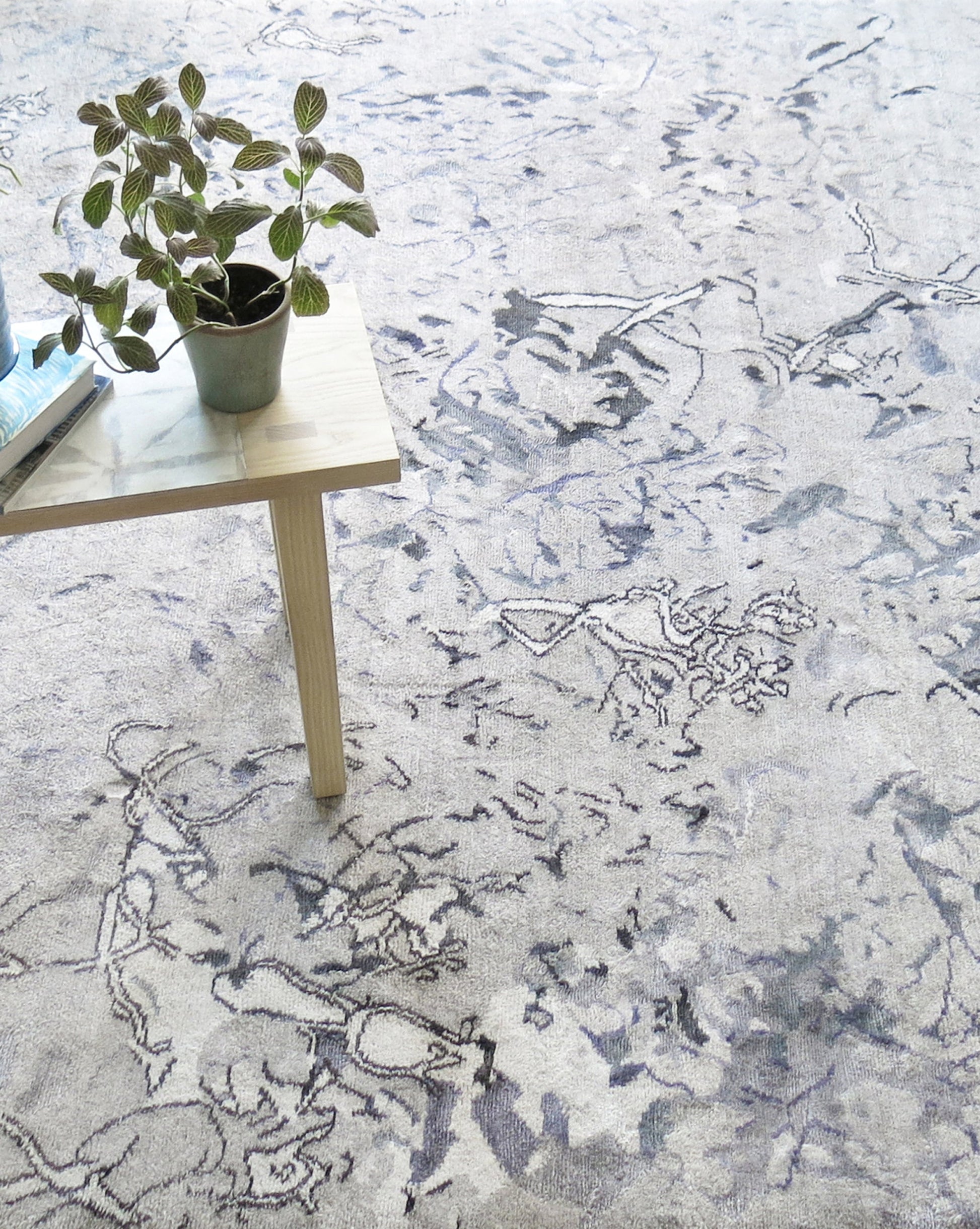 A Bosky Toile Hand Knotted Rug Midnight with a plant on it