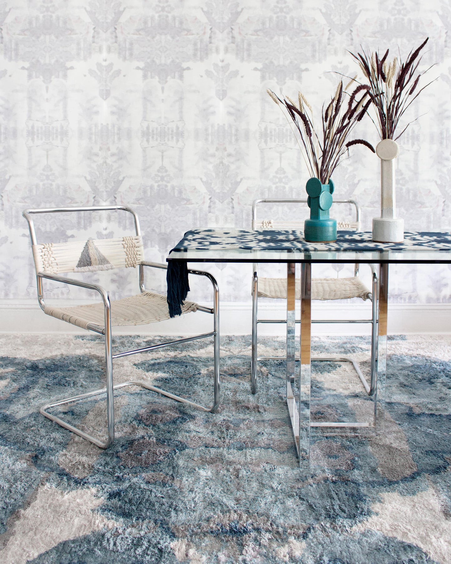 A dining room with a Diego Hand Knotted Rug Slate table and chairs