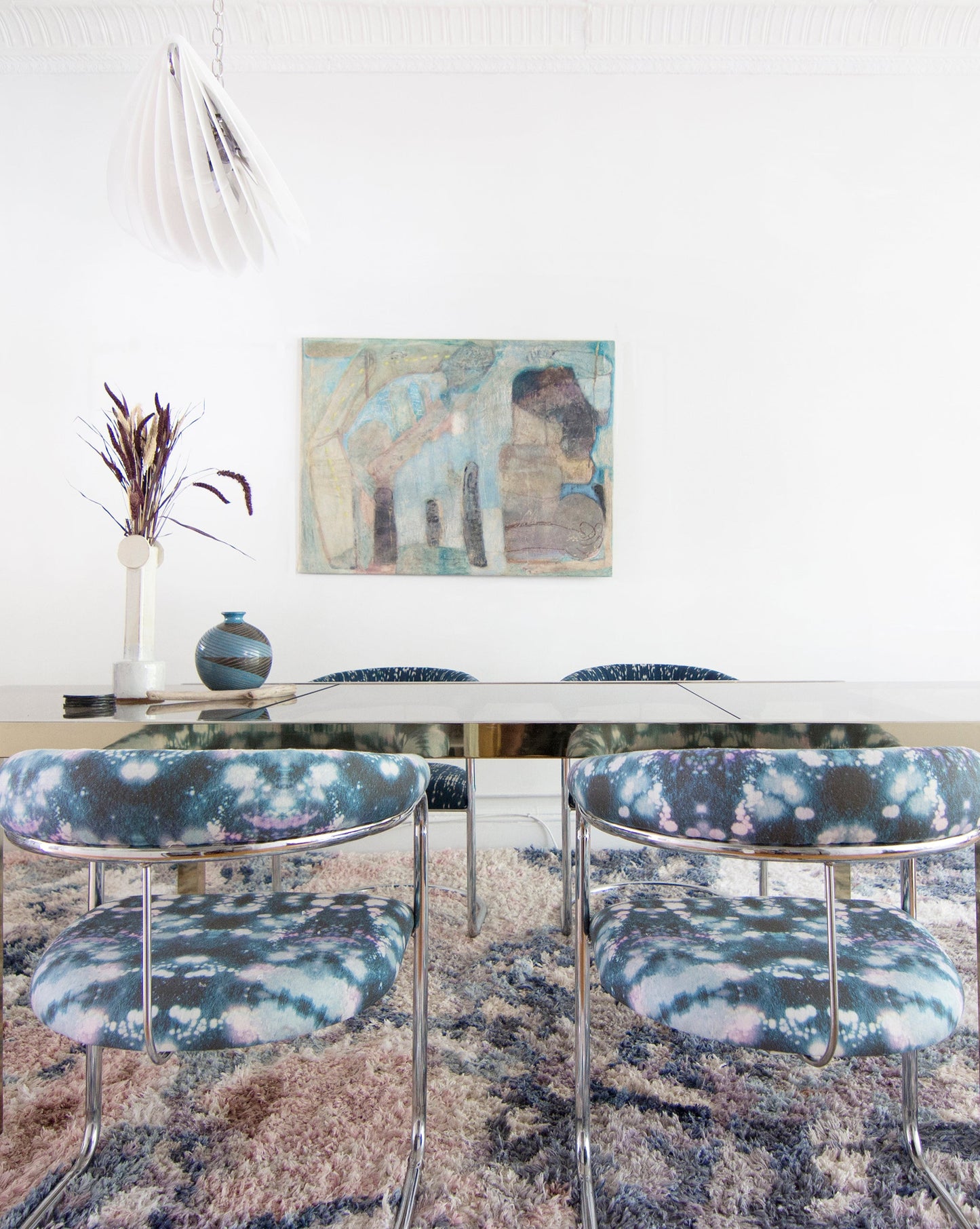 A dining room with blue chairs and a Balboa Hand Knotted Rug Multi from the Presidio Collection luxury handmade rug