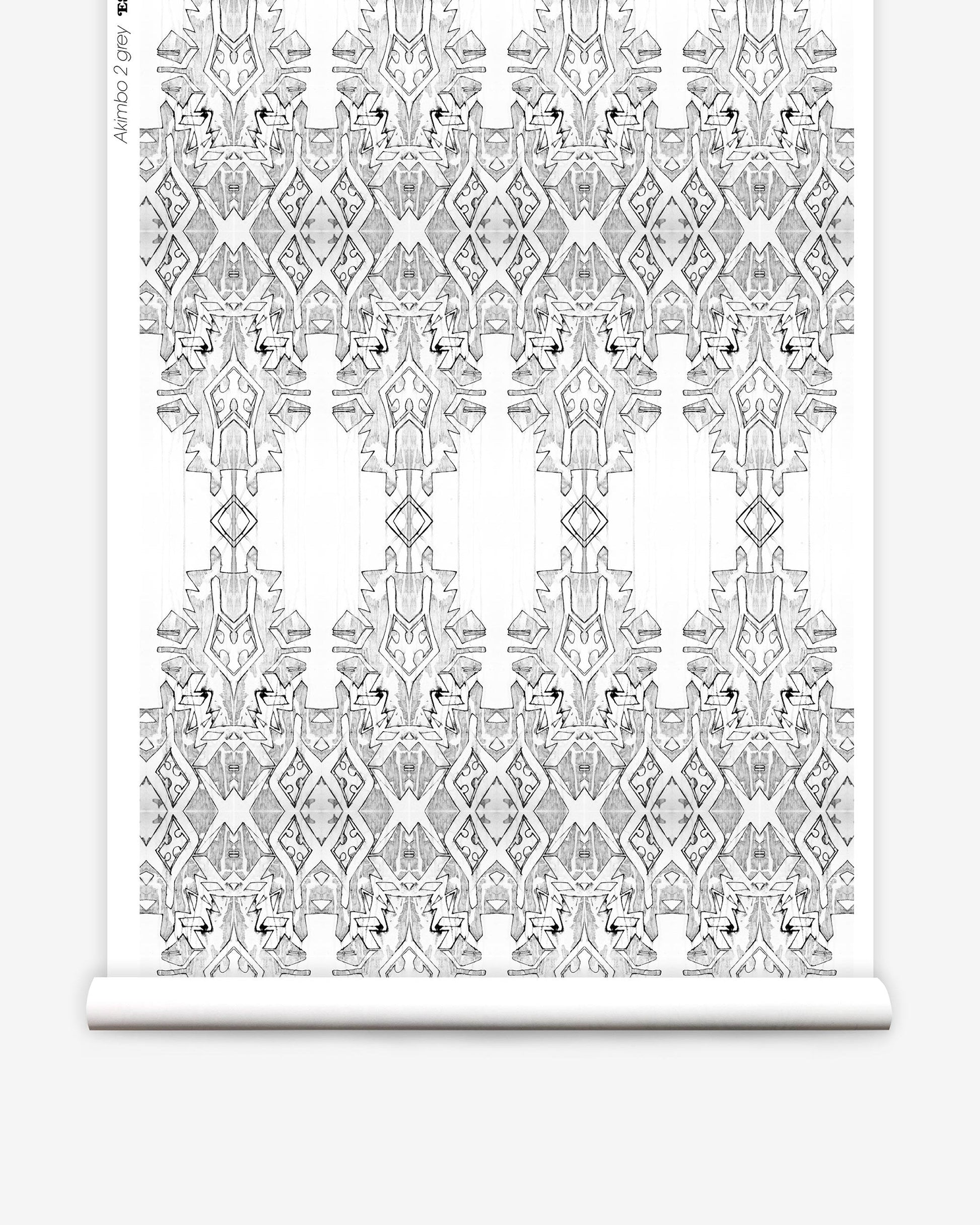 A roll of Akimbo 2 Wallpaper Greyscale, with a monochrome pattern on it, lying akimbo
