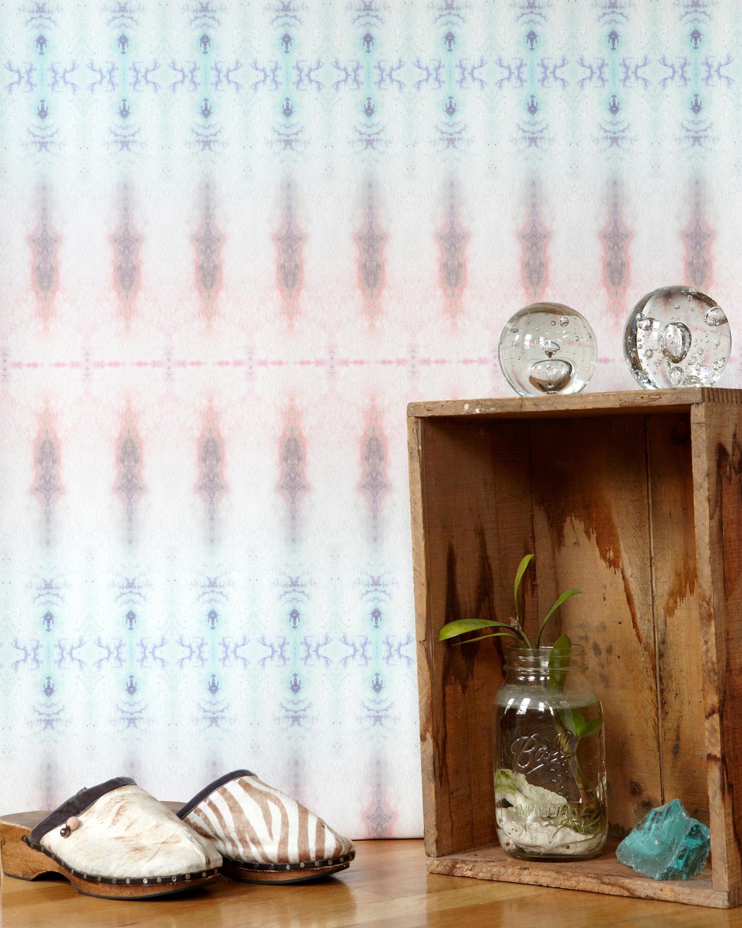 A crate with a pair of Akimbo 7 shoes and a vase on it, showcasing a geometric pattern