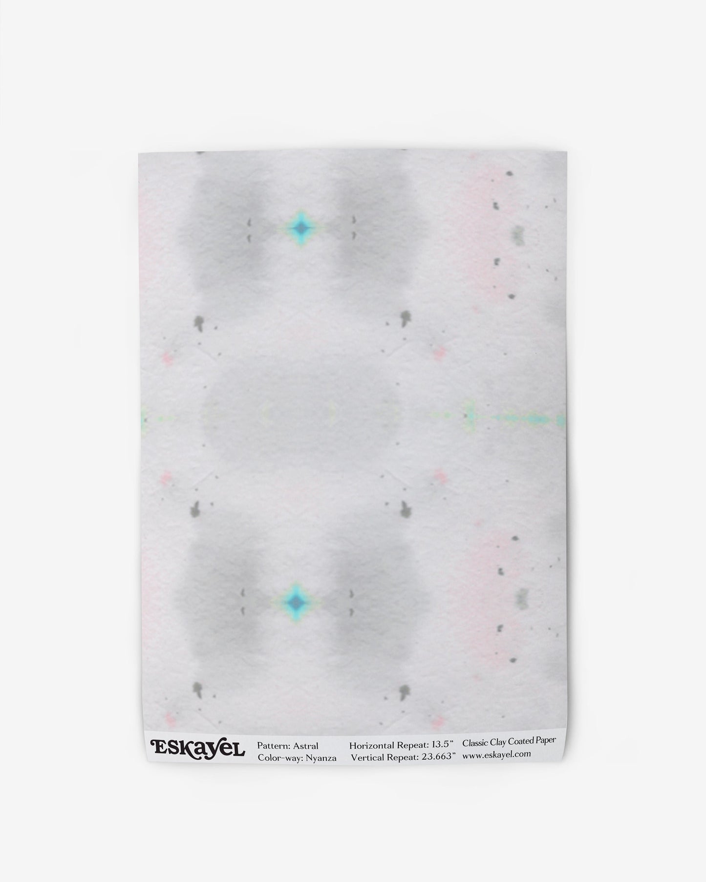 A white wallpaper with a pink, green, and blue pattern from the Astral Wallpaper Nyanza Collection