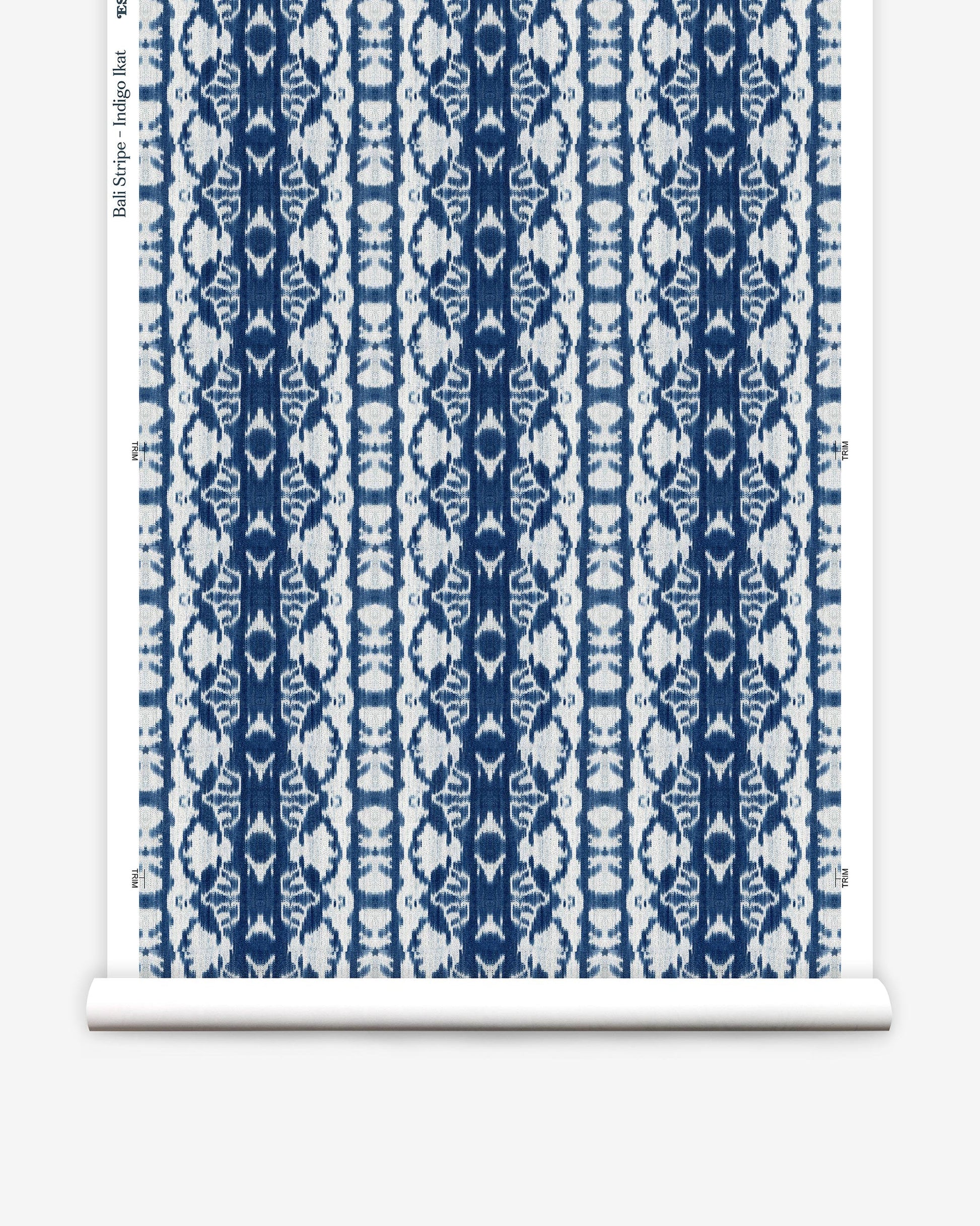 A blue and white damask pattern on a roll of wallpaper with high-end Bali Stripe Wallwallpaper Indigo Ikat