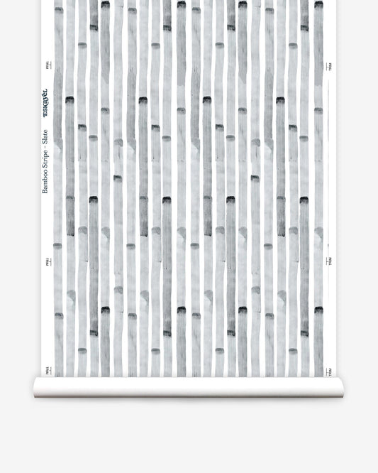 A roll of Bamboo Stripe Wallpaper Slate from Eskayel's high-end Bamboo Stripe range with a black and white pattern on it