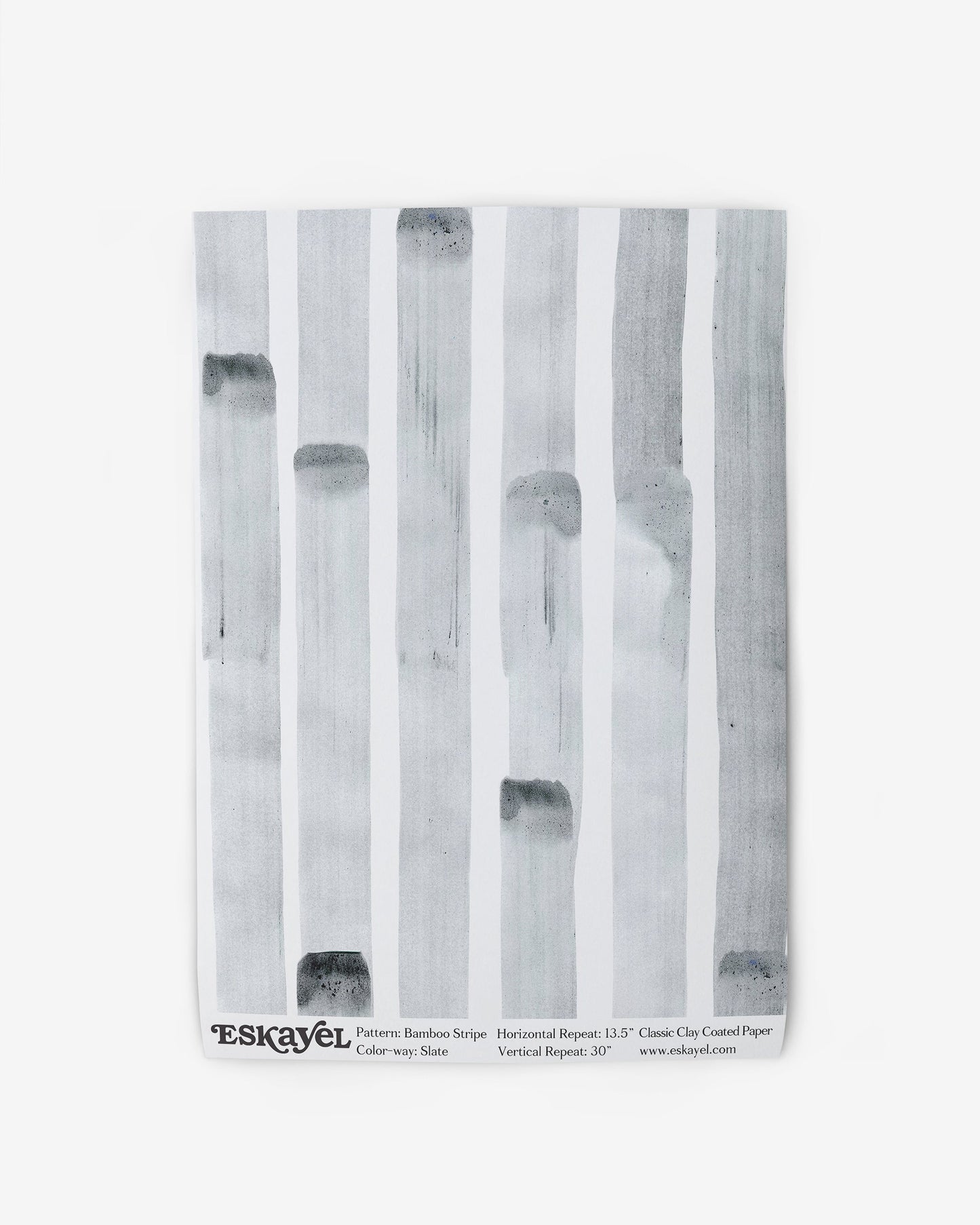 A white Bamboo Stripe Wallpaper Sample Slate wallpaper with black and white stripes on it