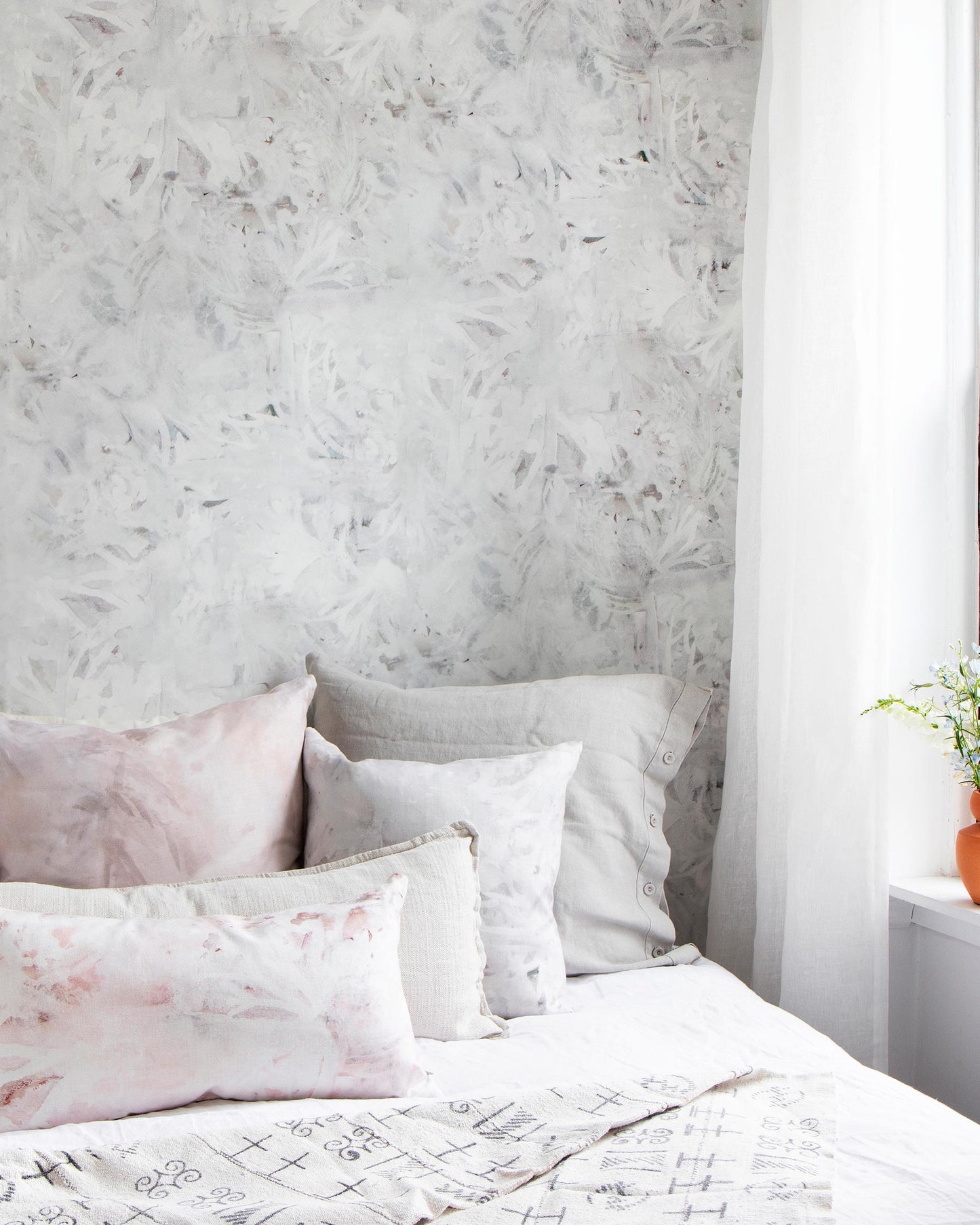 A Cortile Wallpaper Alba bed with pillows on it