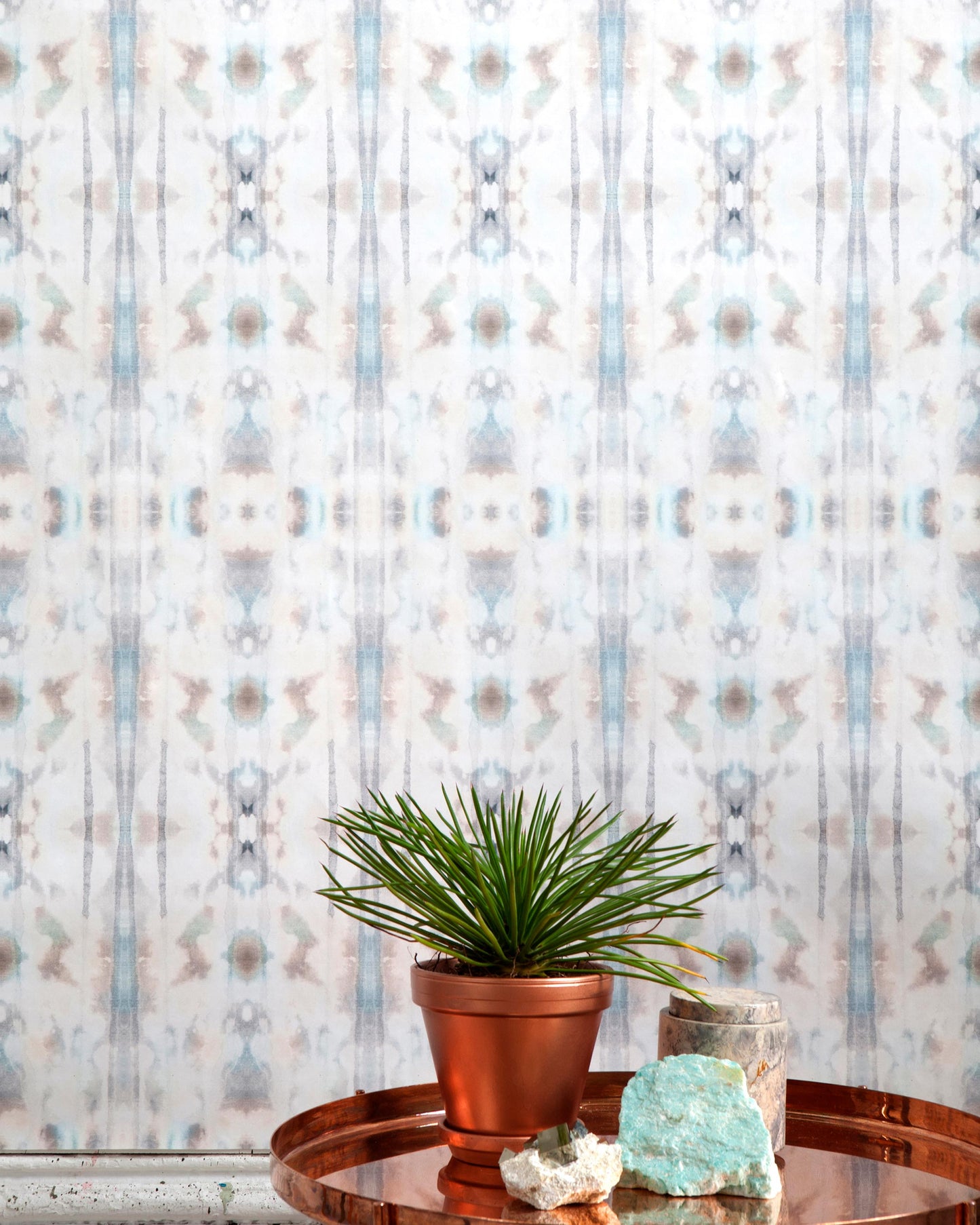 A tray with a plant on it sits on a table in front of Biami Wallpaper Hide