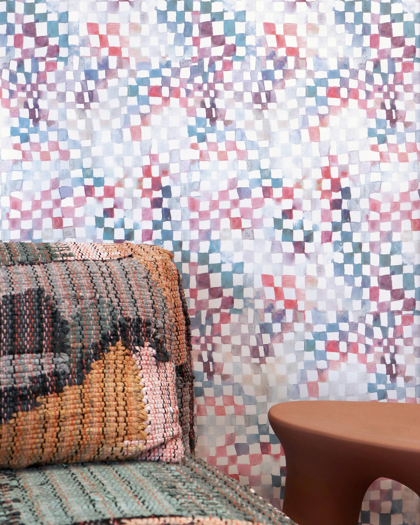 A couch and chair in front of a colorful Chess Wallpaper Reef squares