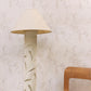 A wooden chair next to a floor lamp with Chess Wallpaper Sol