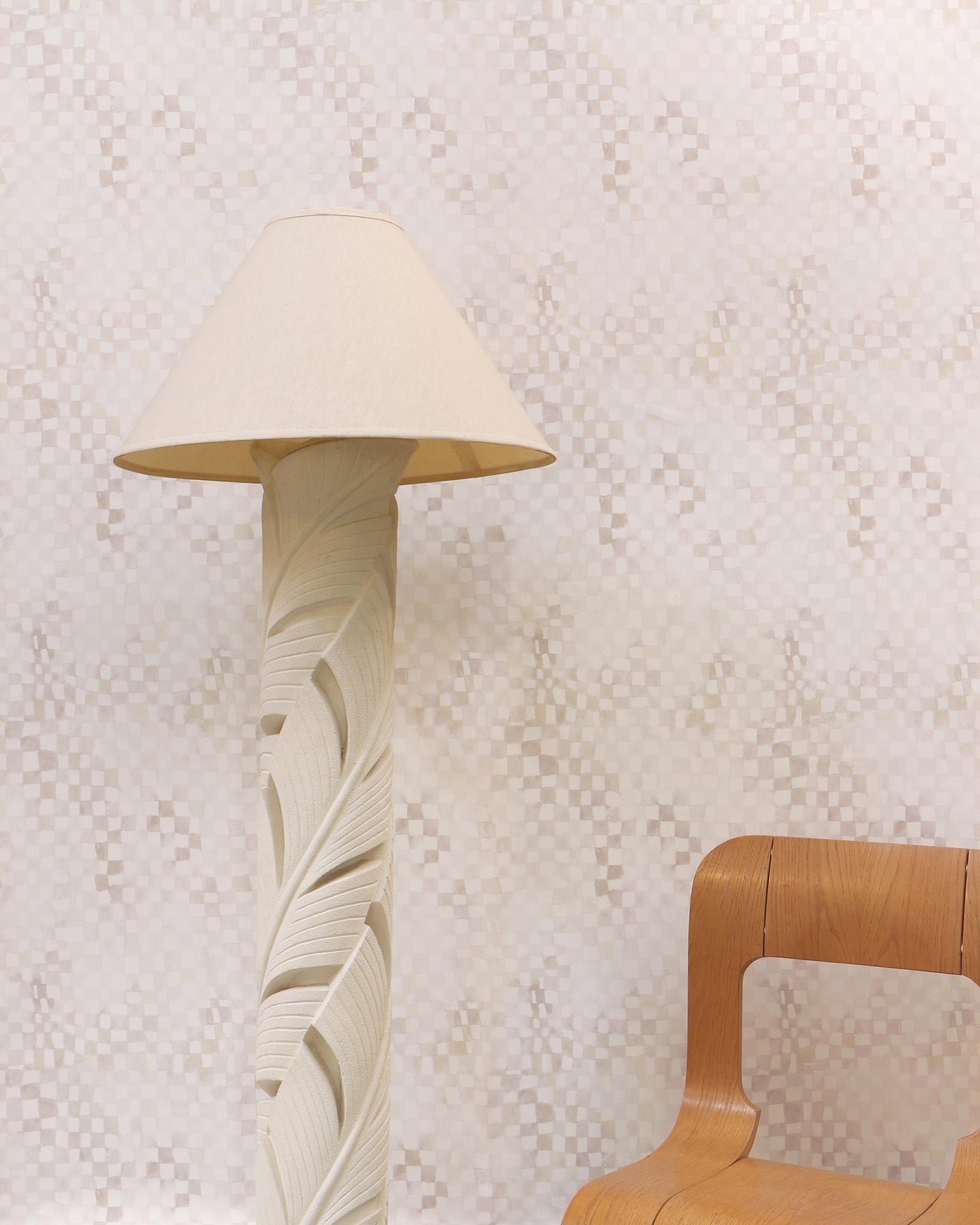 A wooden chair next to a floor lamp with Chess Wallpaper Sol
