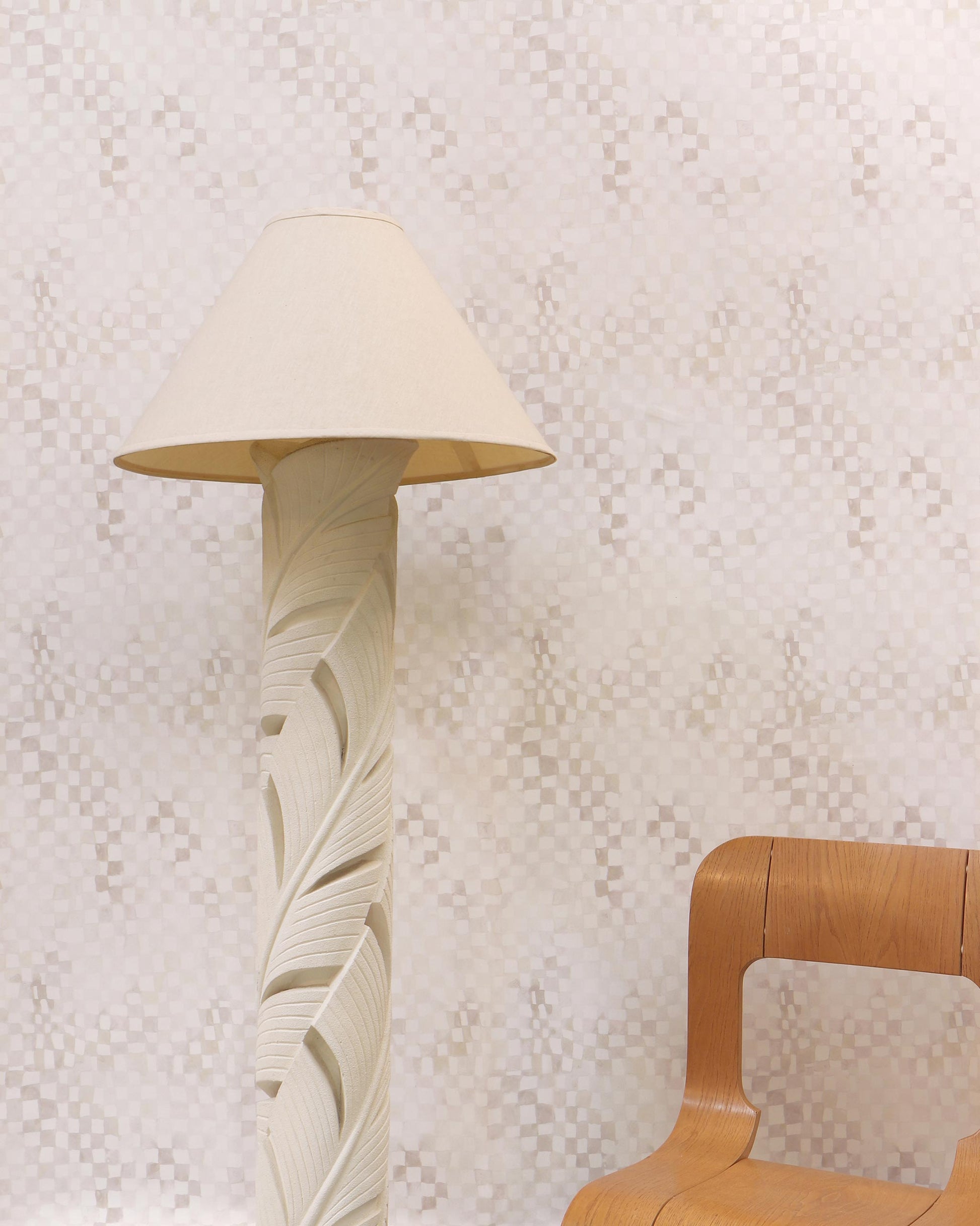 A wooden chair next to a floor lamp with Chess Wallpaper Sol