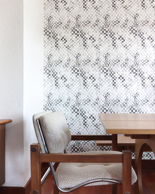 A wooden table and chairs in a room with Chess Wallpaper Grey on the wall